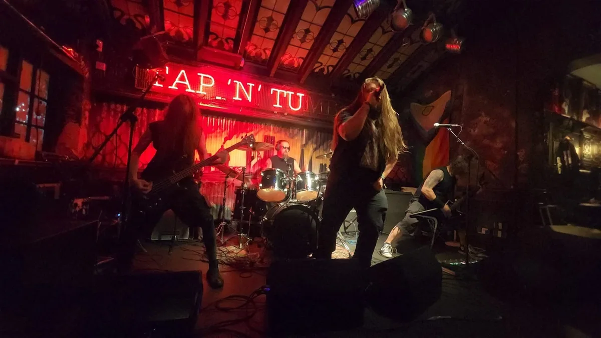 Ashborn live on stage under red lighting